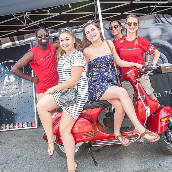 Columbus experiential marketing firm employees on red Vespa