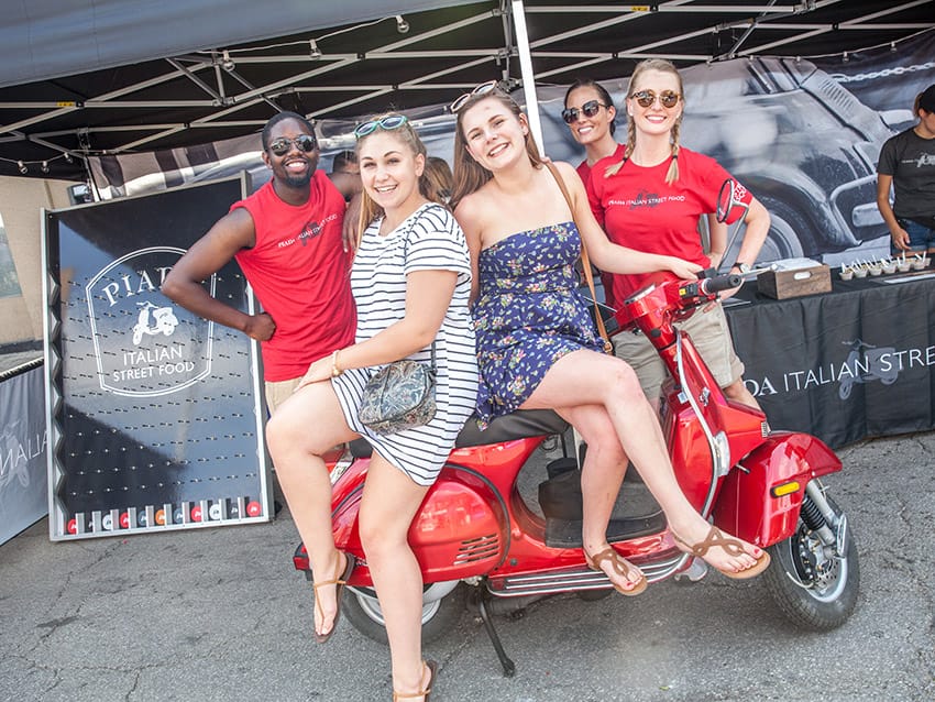 Columbus experiential marketing firm employees on red Vespa